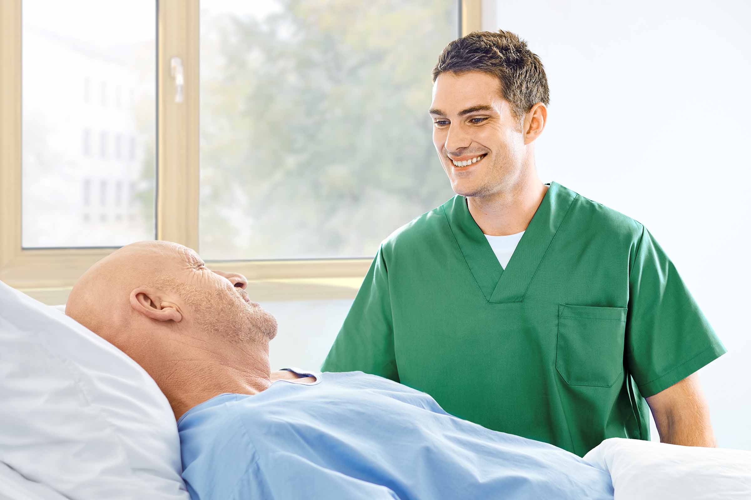 nurse talking with patient at the bedsite