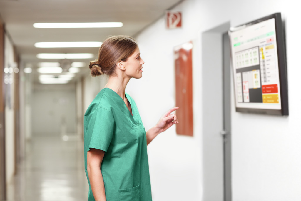 A nurse reading on the information board
